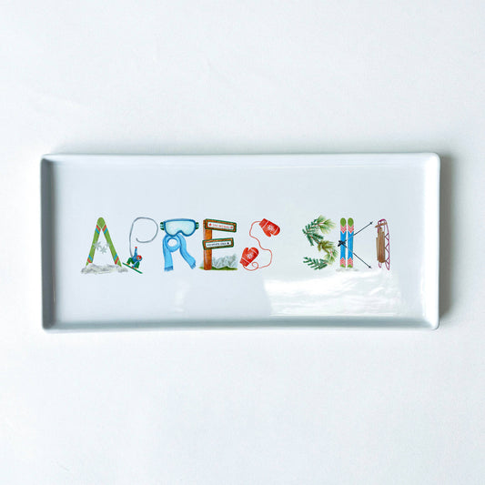 Porcelain tray with colorful letters spelling 'APRES SKI' on a white background