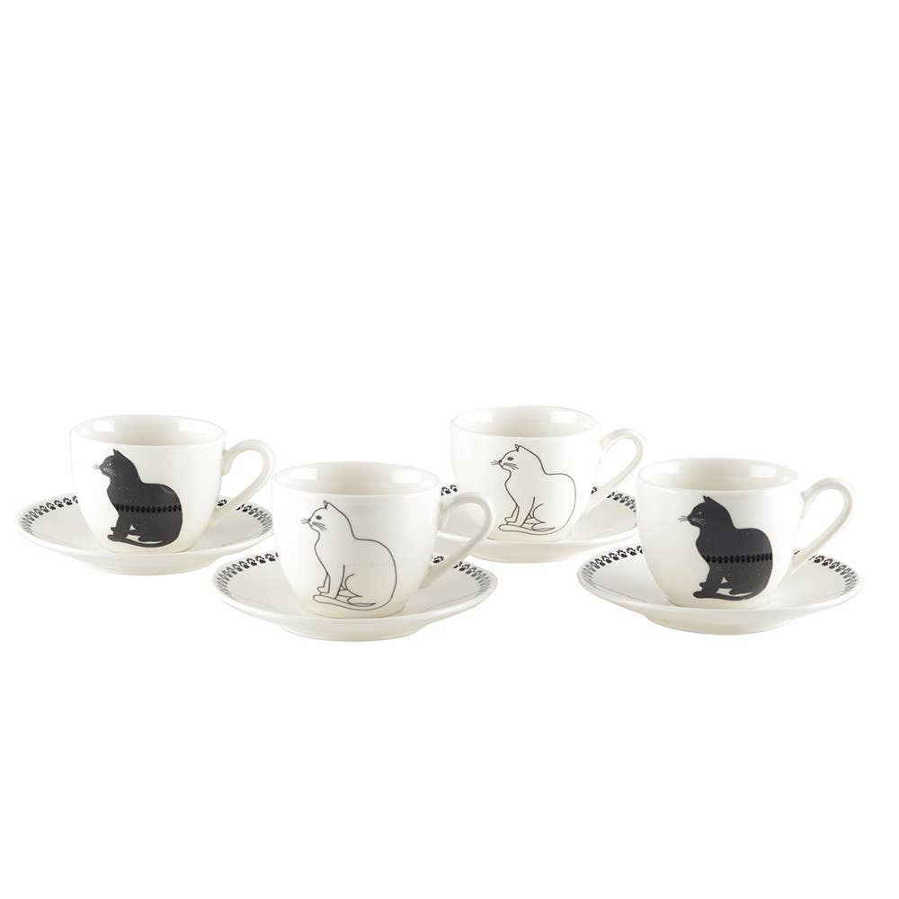 Set of four white tea cups  and saucers with black and white cat illustrations  on a white background
