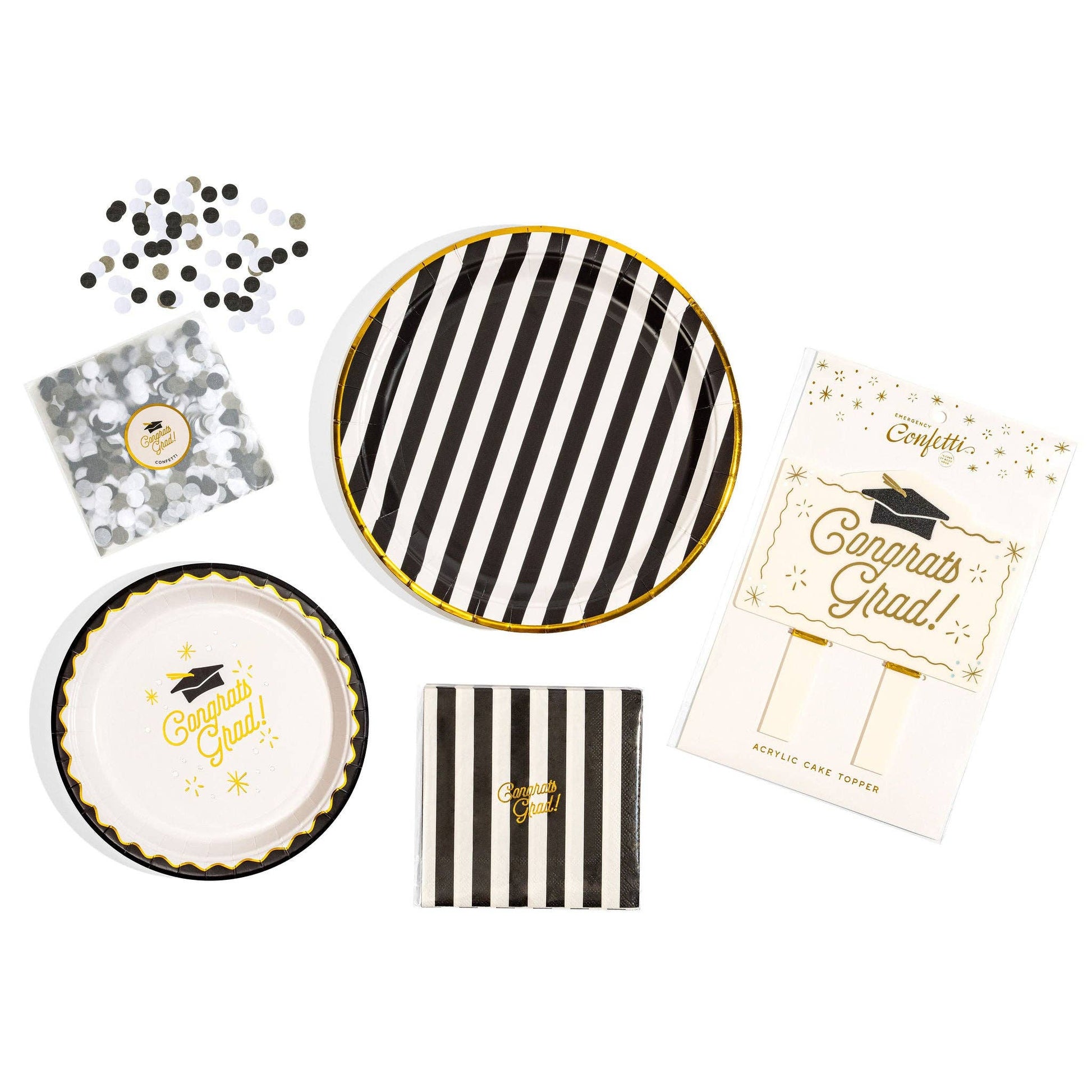 Graduation-themed party supplies including plates, napkins, and a cake topper  