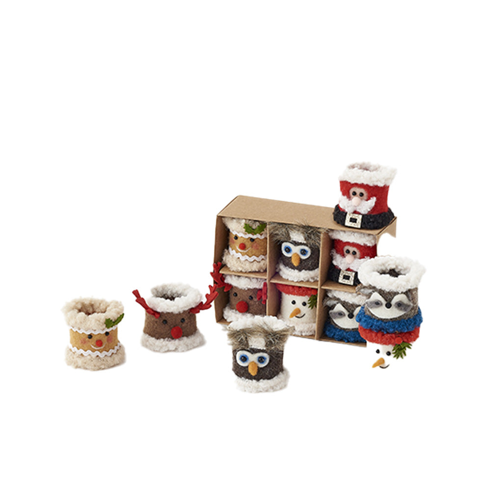 A set of small napkin rings with Christmas characters including Santa, reindeer, owl, snowman.  