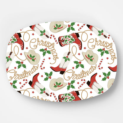 Serving platter with western-themed design featuring boots, hats, and holly leaves with the text Christmas on a white background.