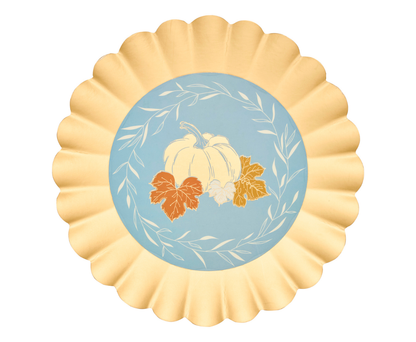 Decorative paper plates with pumpkins and leaves on a blue background