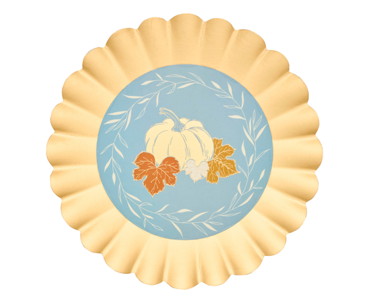 Decorative paper plates with pumpkins and leaves on a blue background