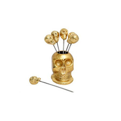 Gold skull-shaped holder with decorative picks