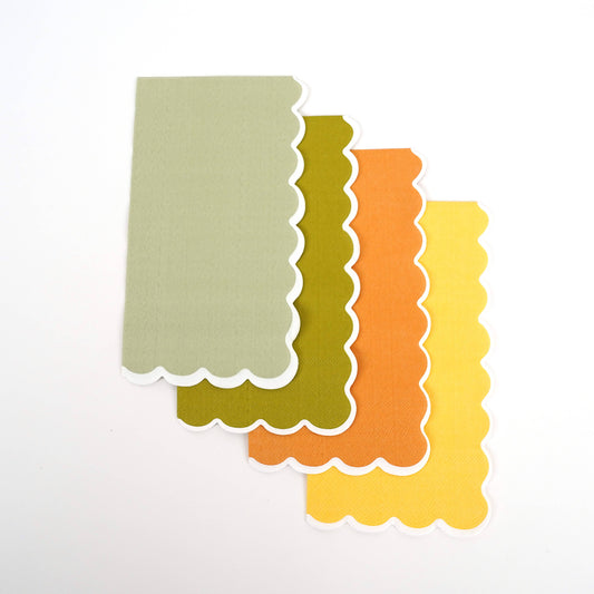 Scalloped-edge paper towel napkins in green, orange, and yellow colors 