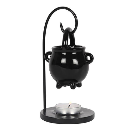Black cauldron-shaped oil burner with a candle