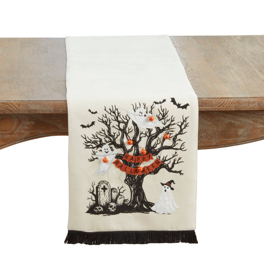 Halloween-themed table runner with tree, ghosts, and tombstones  and a Happy Halloween pennant. 