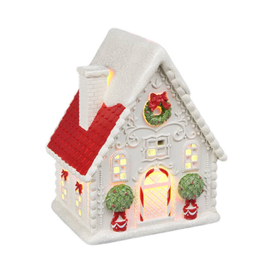 Decorative Christmas house with red roof and LED  lit windows.