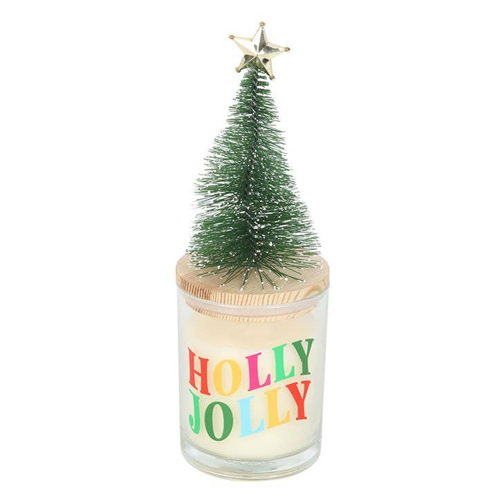 Candle with a small Christmas tree on top of a glass container with the text Holly Jolly in colorful letters
