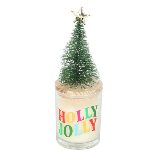 Candle with a small Christmas tree on top of a glass container with the text Holly Jolly in colorful letters