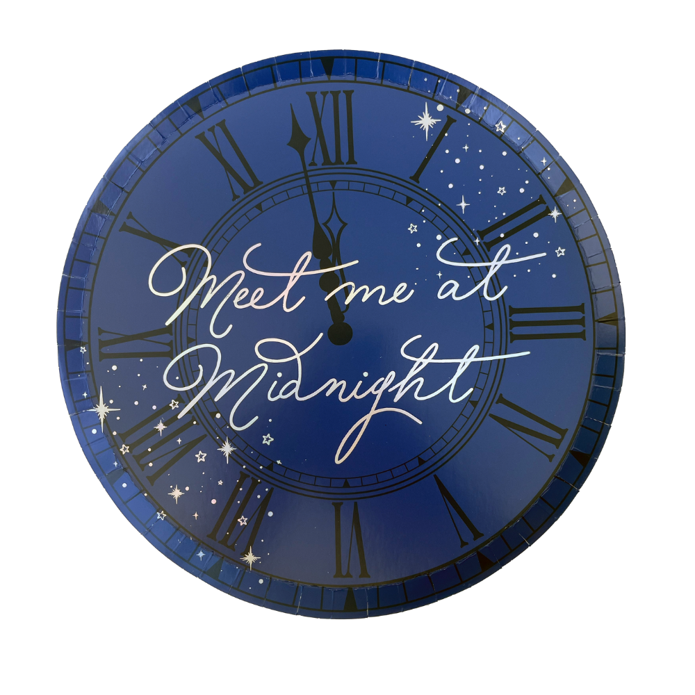 Paper dinner plates with a navy blue clock face with 'Meet me at Midnight' text and star decorations  