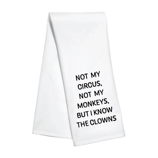 White towel with black text 'Not my circus, not my monkeys, but I know the clowns' 