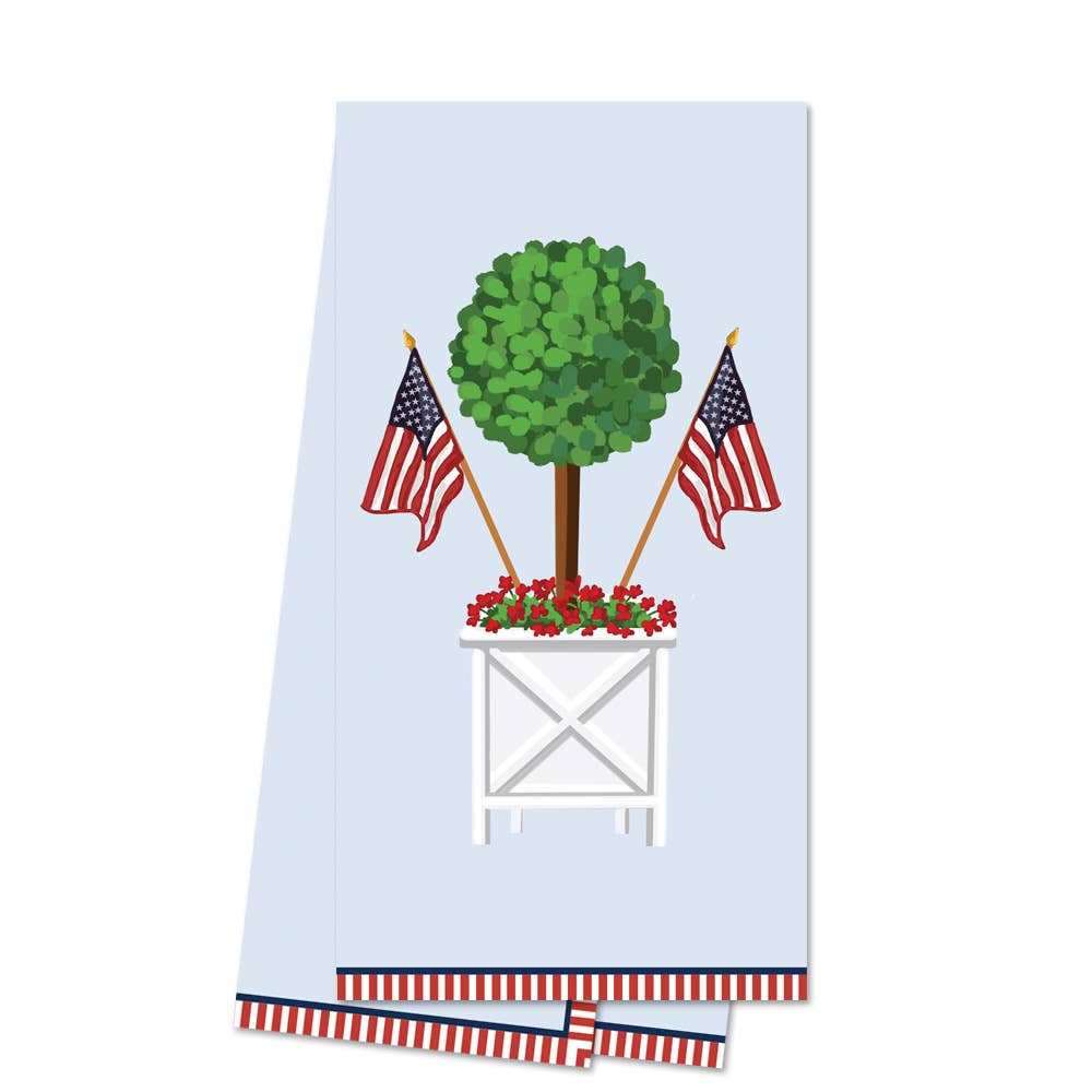 Towel with a design of a topiary, American flags, and a white stand on a light blue background.