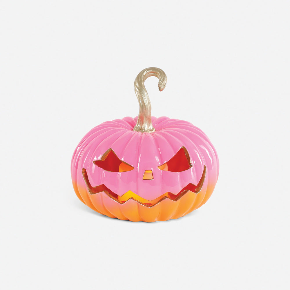 A small jack-o'-lantern decoration with a pink upper body, orange lower body, and a metallic gold stem.