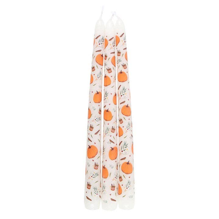 Set of three candles with pumpkin pattern on a white background