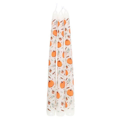 Set of three candles with pumpkin pattern on a white background