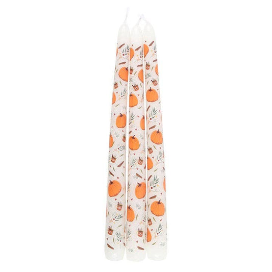 Set of three candles with pumpkin pattern on a white background