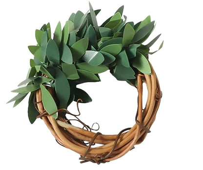 Napkin rings made of rattan with artificial green leaves.