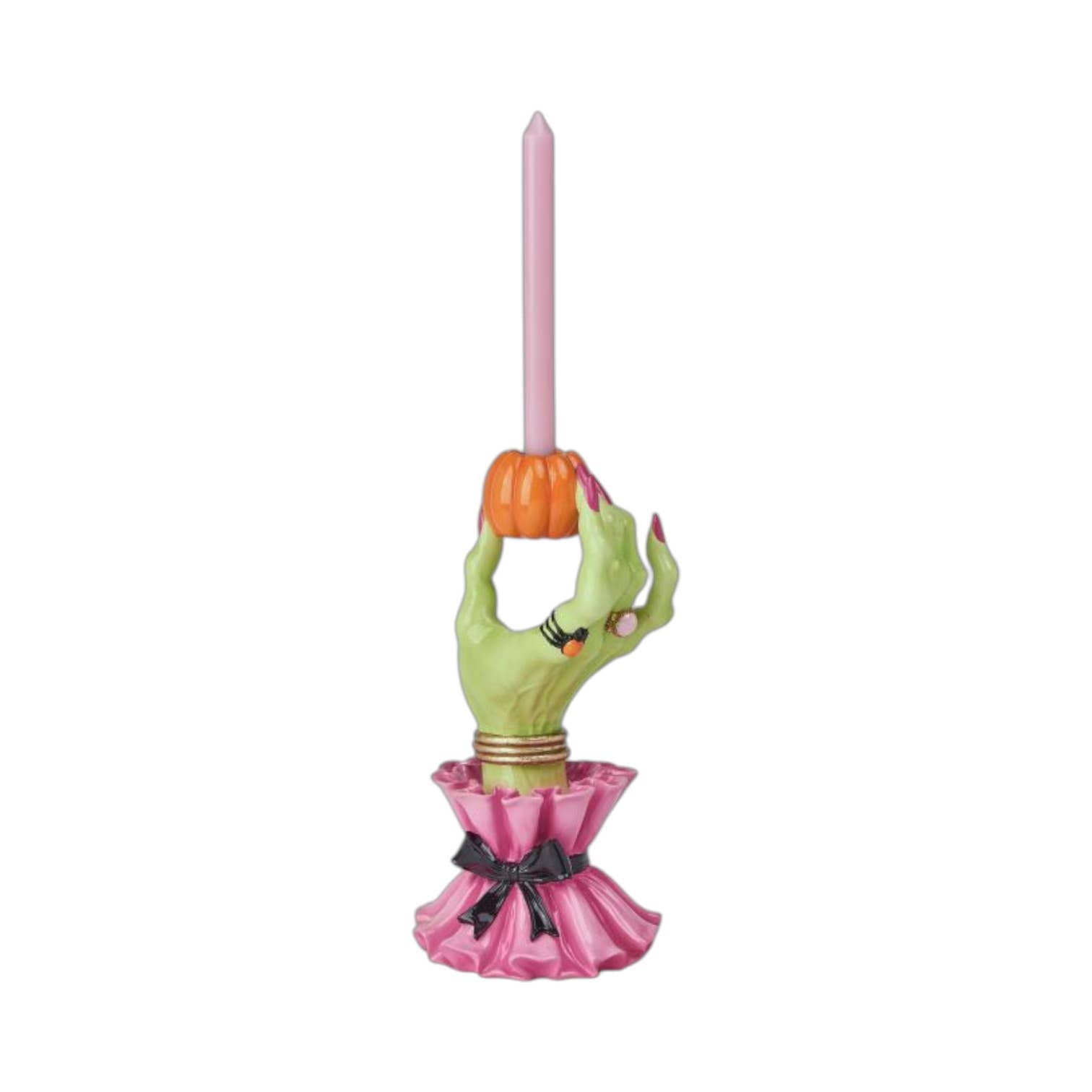 Halloween-themed candle holder with green witch hand holding a miniature pumpkin