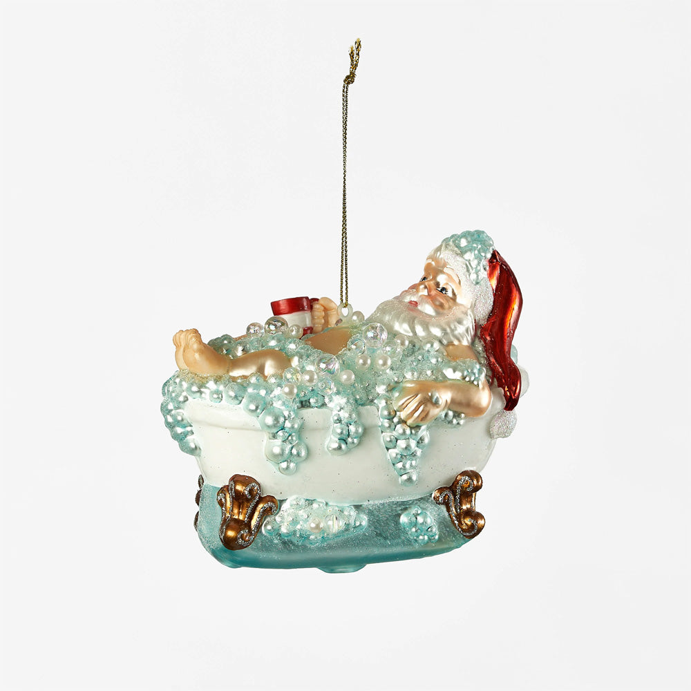 A ornament depicting Santa relaxing in a bathtub filled with bubbles.