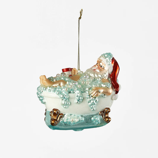 A ornament depicting Santa relaxing in a bathtub filled with bubbles.