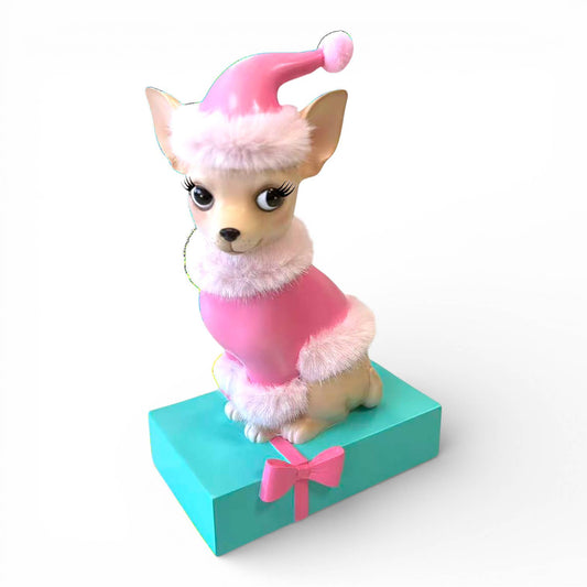Sophie Dog figurine in a pink outfit with a hat on a turquoise box