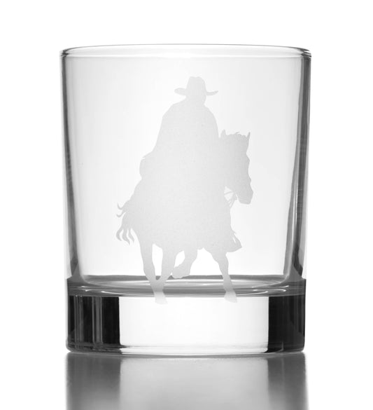 Clear glass tumblers with a  silhouette of a person on horseback engraved on it.